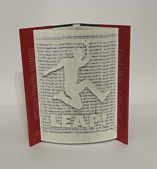 A book sculpture that shows a leaping man and the word "Leap!" Created by Virginia Beach artist, Maggie Kerrigan