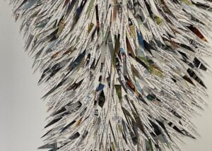 A collage by artist Maggie Kerrigan that implies melting glaciers and uses paper cut from encyclopedias.