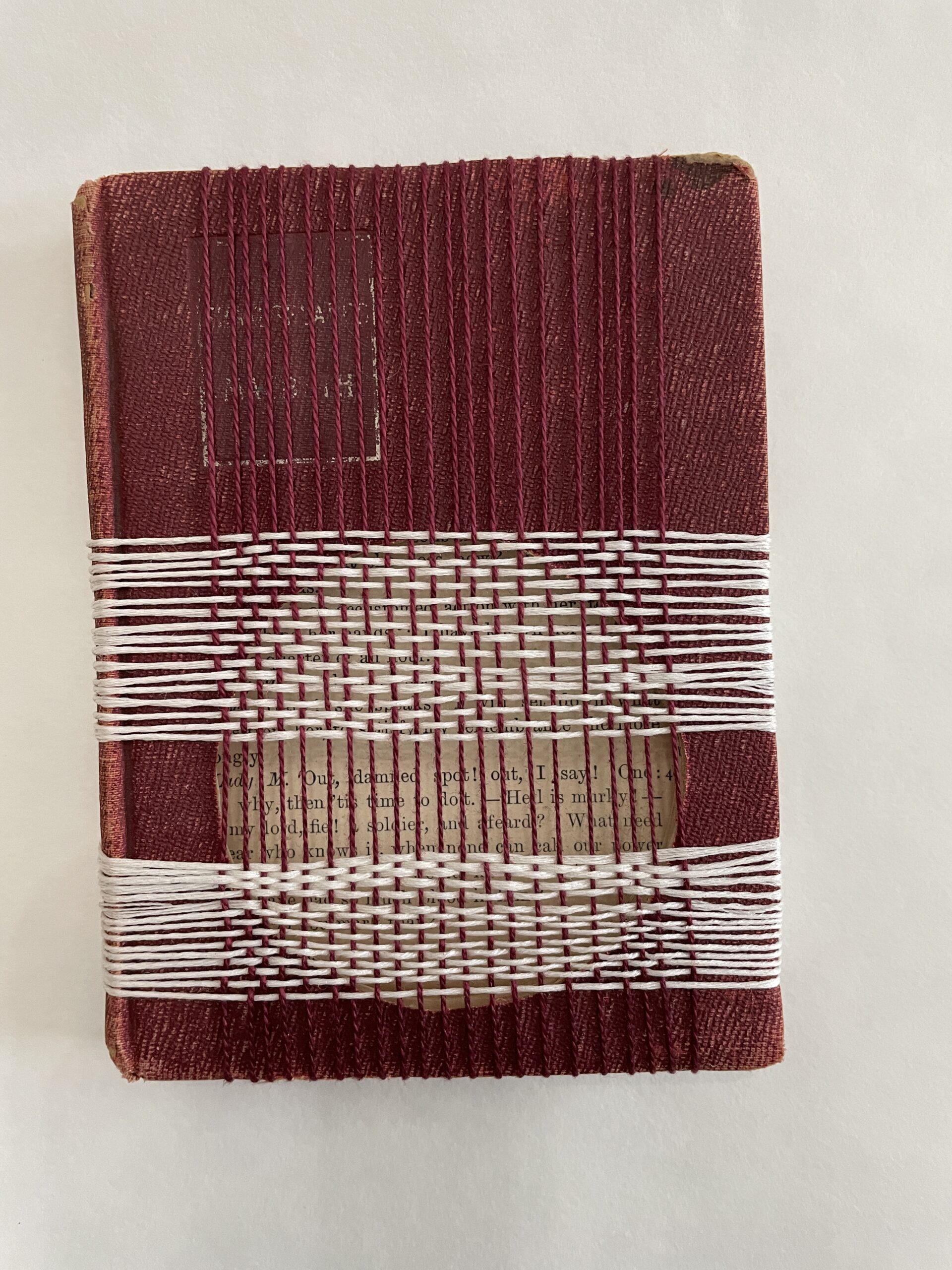 A 1898 copy of Macbeth has been cut to reveal the passage of the play with Lady Macbeth's famous line. The artist, Maggie Kerrigan, then wove the thread to bind the rest of the book together and encapsulate the famous words.